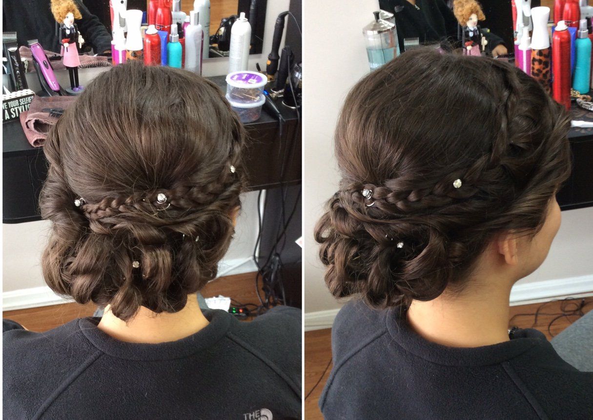 Side and back views of an elegant low updo with braided twists and pearl hairpins in a salon