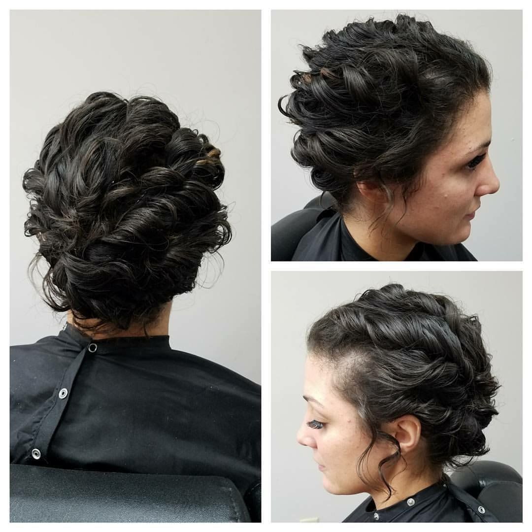 Three views of an elegant dark updo hairstyle on a model in a salon chair